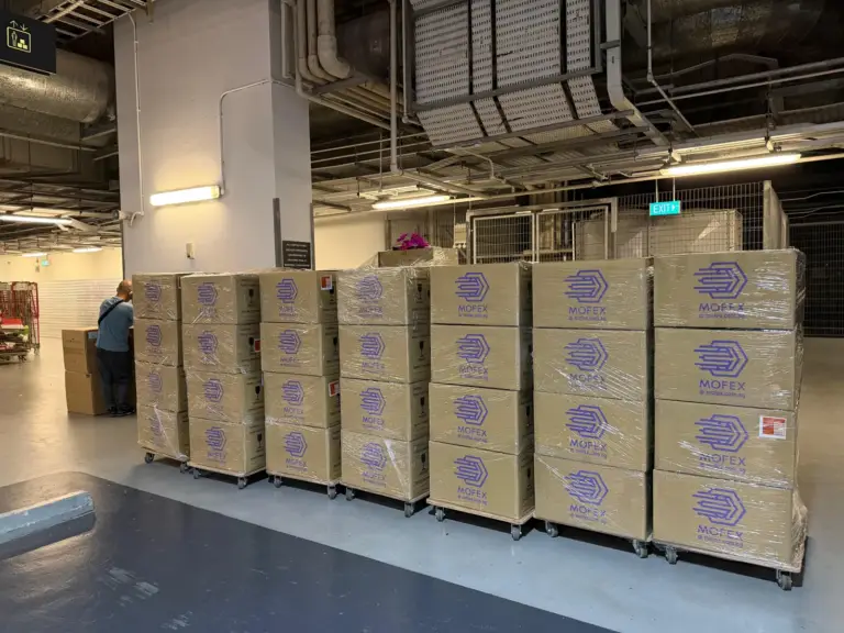 Rows of packed Mofex boxes on trolleys during a large office move