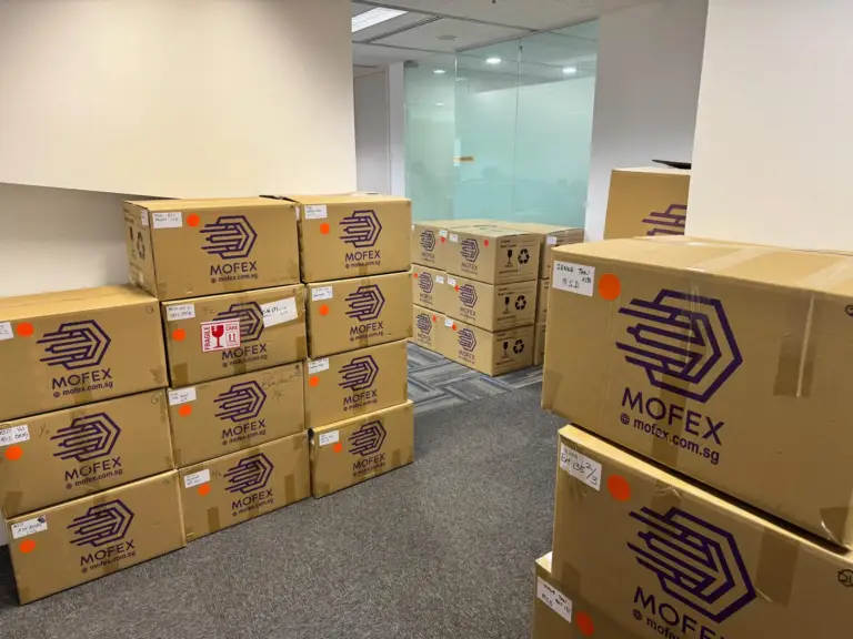 Stacks of Mofex-branded moving boxes in an office ready for relocation