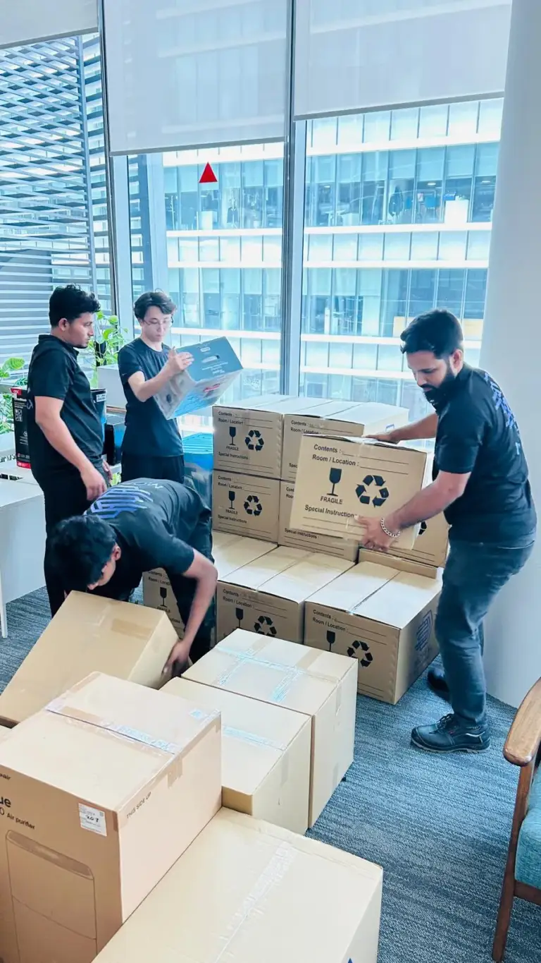 Mofex crew packing office boxes by the window