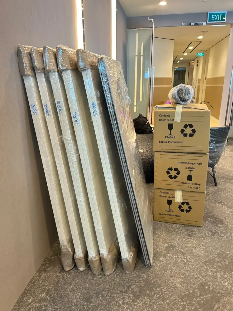 Wrapped desk panels and Mofex cartons lined up for an office move
