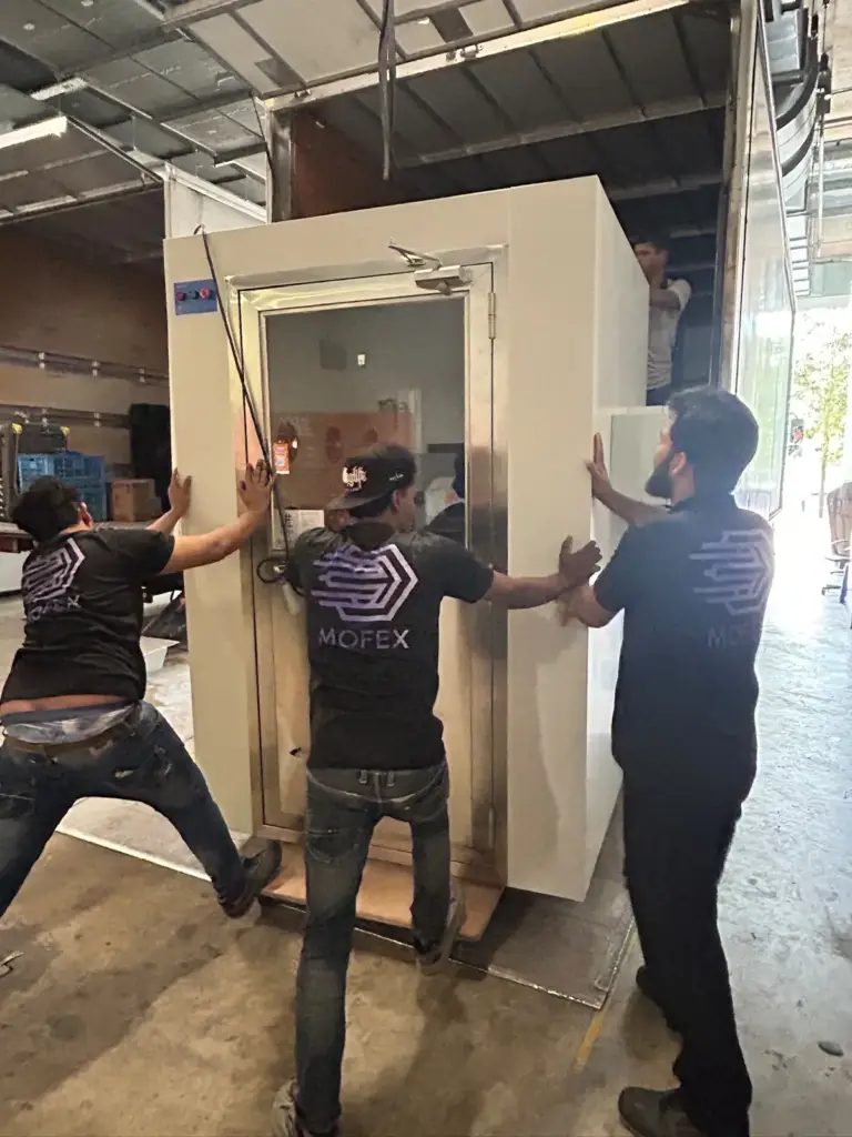 Mofex movers unloading a large cleanroom unit from a lorry