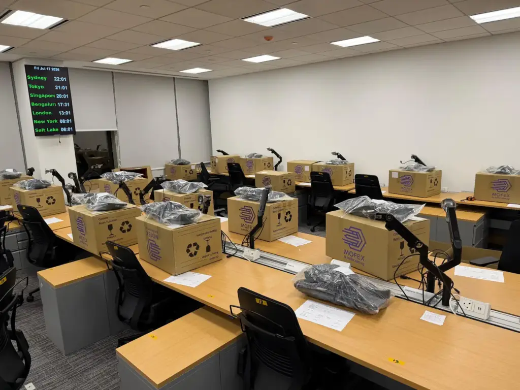 Office workstations at the new office with a labelled Mofex box placed on each desk, ready for staff